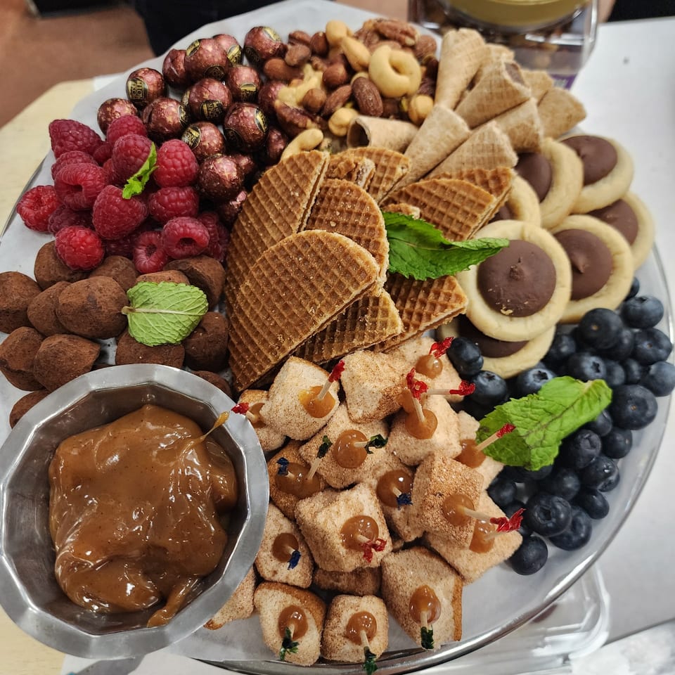 Dessert platter with cookies, chocolates and berries