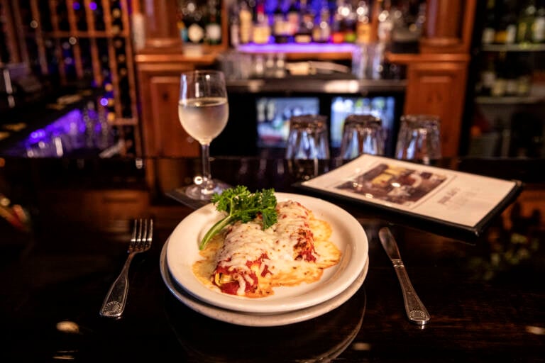 Baked manicotti served in a warm Italian restaurant setting